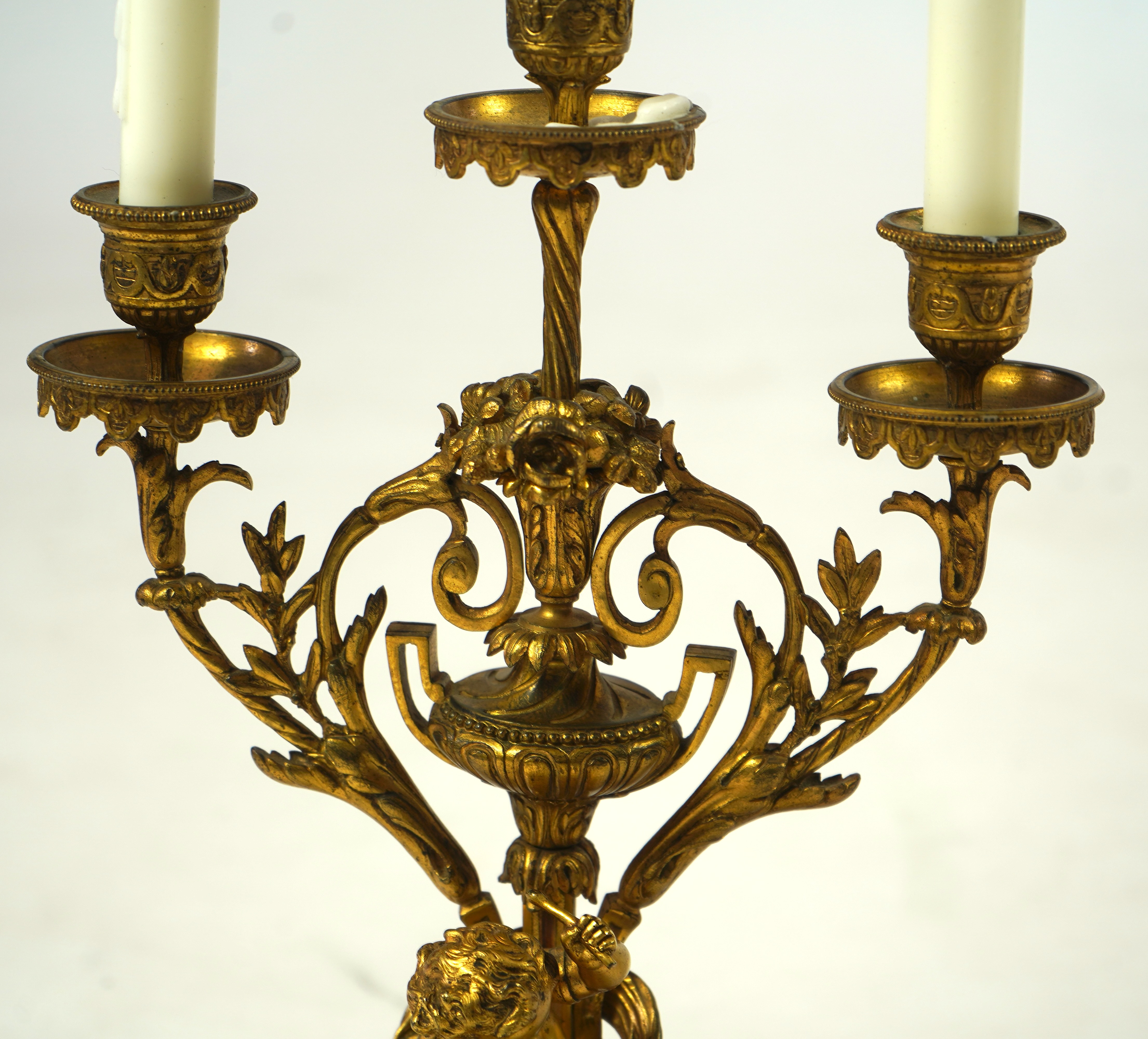 A pair of 19th century French Louis XVI style ormolu three light candelabra